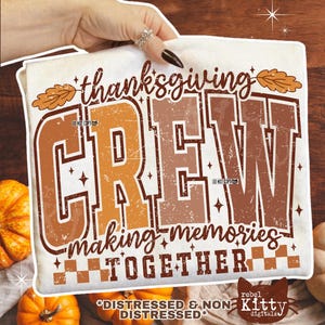 May include: A cream-colored t-shirt with the words "thanksgiving CREW making memories TOGETHER" in brown and orange distressed lettering. The shirt has a fall theme, with leaf graphics and a checkered pattern. A pumpkin is visible in the background.