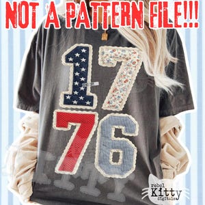 May include: Gray t-shirt with the number "1776" appliqued on the front. The "1" is blue with white stars, the "7" has a floral pattern, the second "7" is red with white polka dots, and the "6" is blue gingham. The text "NOT A PATTERN FILE!!!" is at the top.