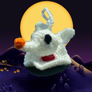 May include: A white crocheted ghost with orange and red accents, a black eye, and a red bow tie. The ghost is in front of a yellow moon and a dark purple background with jack-o-lanterns.