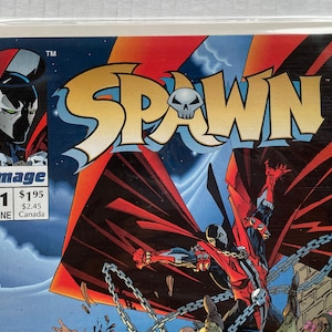 May include: Comic book cover featuring Spawn, a red and black superhero with horns and a cape, fighting against a group of enemies. The cover is titled "Spawn" with the issue number "11" and the month "June".