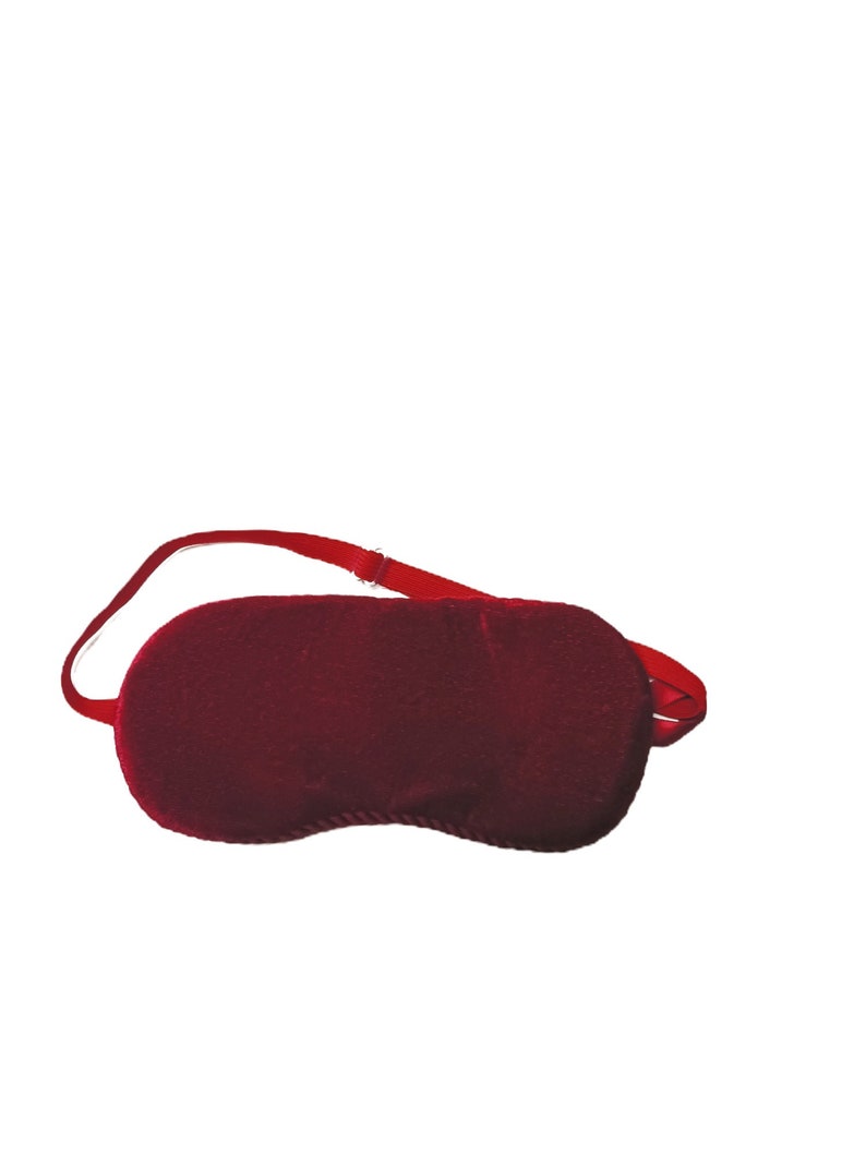 Red Sleep Mask with an adjustable strap.