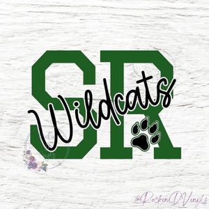 May include: Green and black vinyl decal with the letters "SR" and the word "Wildcats" in a cursive font. A black paw print is in the lower right corner of the decal.