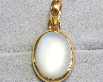 May include: A gold pendant with a white oval moonstone.