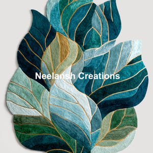 May include: A leaf-shaped rug in shades of teal, blue, and green, with gold-colored accents. The rug features a layered design with the text "Neelansh Creations". The rug is a decorative home accent.
