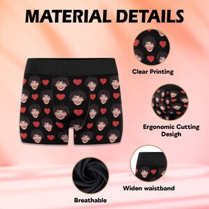 May include: Black boxer briefs with a repeating pattern of red hearts and a person's face. The underwear has a wide waistband, breathable fabric, and an ergonomic cut. The text "Clear Printing", "Ergonomic Cutting Design", "Widen waistband", and "Breathable" are visible.