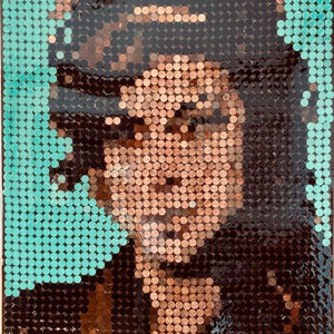 May include: A mosaic portrait constructed from numerous circular copper coins and teal-colored discs. The arrangement of the coins creates a detailed image of a face with dark hair, set against a vibrant teal background of circular elements.