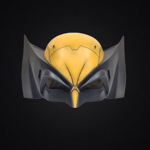 May include: A Wolverine-style mask in yellow and dark gray. The mask has a rounded top with angular details and pointed ear-like extensions on each side. The eye openings are dark, and the nose area is pointed.