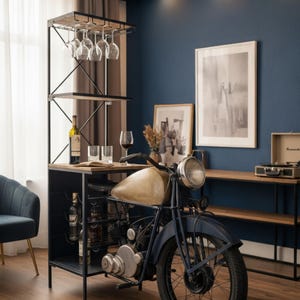 May include: A unique bar cabinet featuring a vintage motorcycle design. The cabinet has a black metal frame with wooden shelves and a wine glass rack. A motorcycle is integrated into the design, with a tan fuel tank and blue fenders. Wine bottles and glasses are displayed.