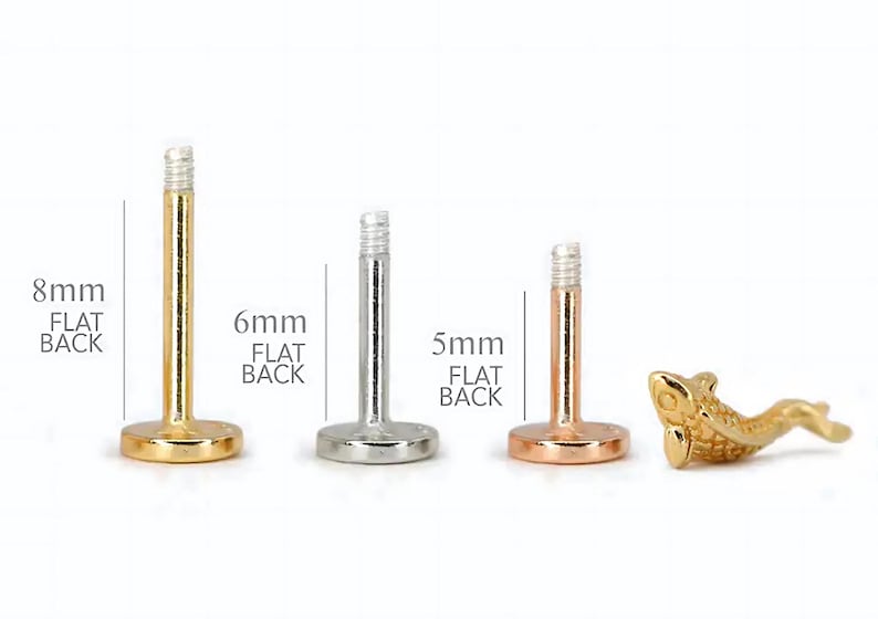 May include: Three different sizes of flat back labret studs, 8mm, 6mm, and 5mm. The studs are made of gold, silver, and rose gold. The 8mm stud is gold, the 6mm stud is silver, and the 5mm stud is rose gold.