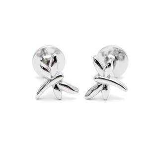 May include: A pair of silver-toned stud earrings shaped like dragonflies. Each earring features a polished, reflective surface with smooth, curved wings and a slender body design. The studs include circular backings visible behind the dragonfly motif.