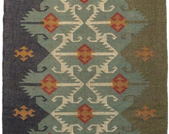 May include: A handwoven rug with a geometric pattern in shades of green, brown, and red. The rug has a fringe border.