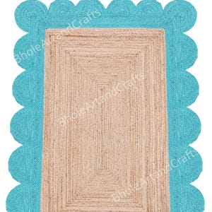 May include: A rectangular jute rug with a light brown centre and a turquoise scalloped border. The rug has a woven texture and a geometric design. The text "BholeArtandCrafts" is visible on the rug.