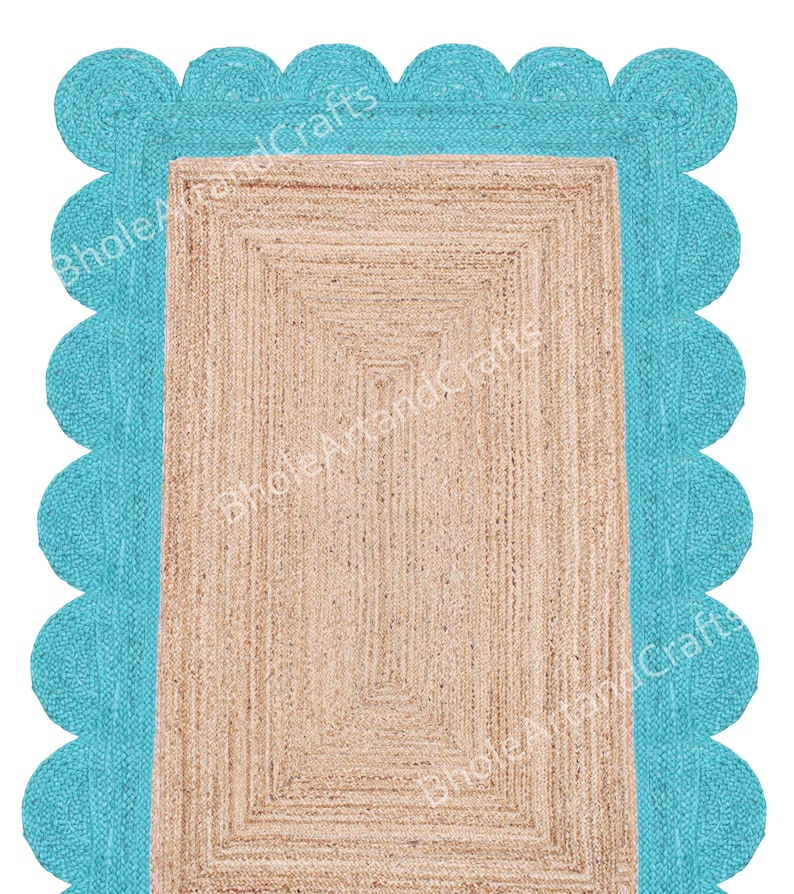 May include: A rectangular jute rug with a light brown centre and a turquoise scalloped border. The rug has a woven texture and a geometric design. The text "BholeArtandCrafts" is visible on the rug.