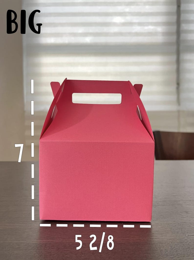 May include: A bright pink cardboard gift box with a handle. The box is 7 inches tall and 5 2/8 inches wide.