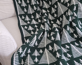 May include: A green and white crocheted throw blanket with a repeating pattern of stylized pine trees.