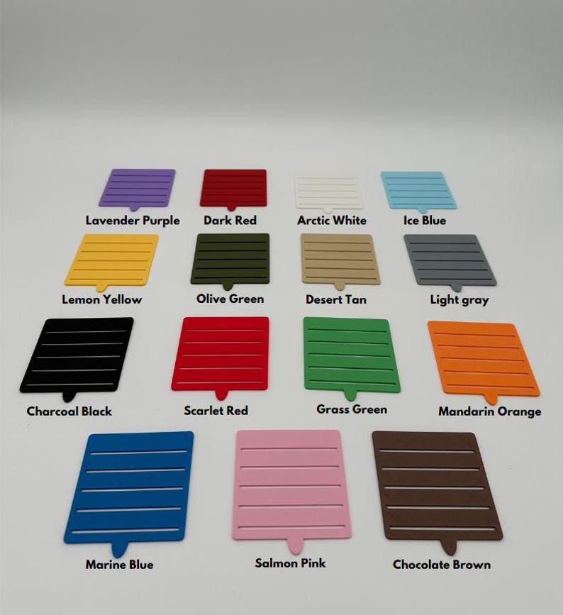 May include: A collection of 15 color swatches, each with a different color name printed below. The swatches are arranged in three rows of five. The colors include lavender purple, dark red, arctic white, ice blue, lemon yellow, olive green, desert tan, light gray, charcoal black, scarlet red, grass green, mandarin orange, marine blue, salmon pink, and chocolate brown.