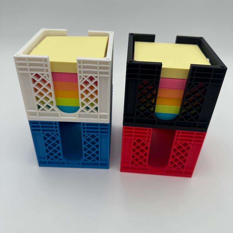 May include: Two stacked mini crate organizers, one white and blue, the other black and red, each holding a stack of colorful sticky notes.
