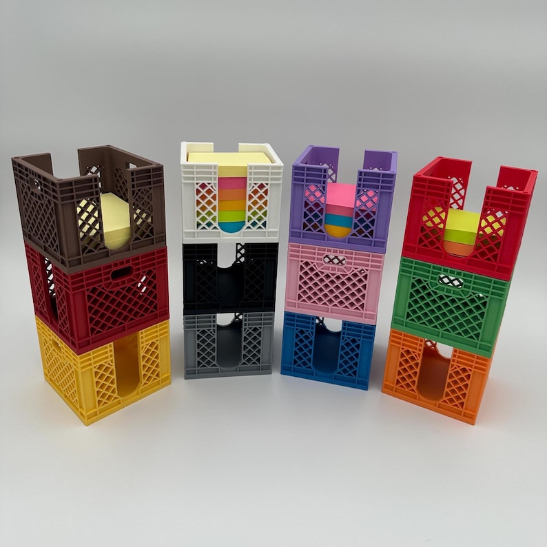 May include: A set of six colorful stackable crates with different colored sticky notes inside. The crates are made of plastic and have a grid pattern. The sticky notes are in various colors, including pink, blue, green, and yellow.