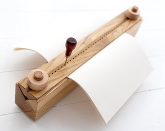 Bookbinding cradle for punching book pages