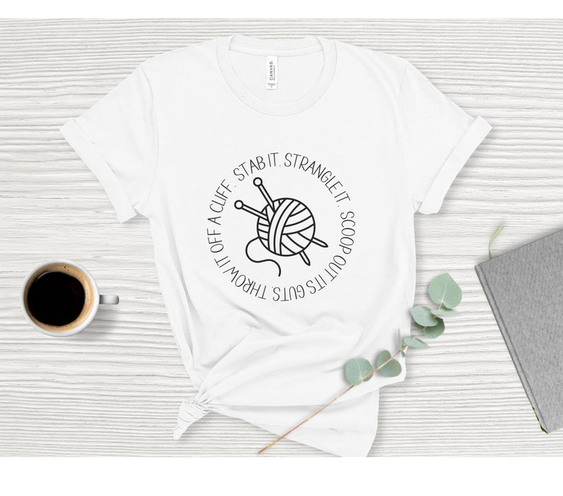 May include: White t-shirt with a black and white graphic of a ball of yarn with knitting needles and the text "It's got's guts. Throw it off a cliff. Stab it. Strangle it. Scoop it out."