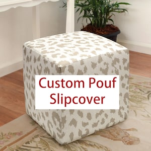 May include: Square ottoman with a neutral leopard print slipcover. The text "Custom Pouf Slipcover" is displayed on the front. The ottoman is placed on a patterned rug.