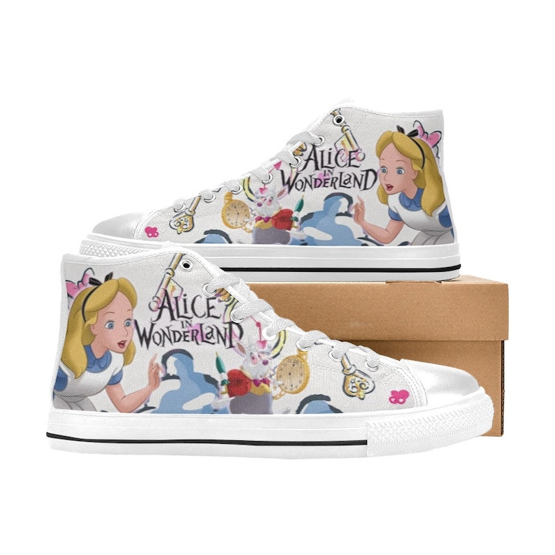 May include: White high-top canvas shoes with a colorful print featuring Alice in Wonderland characters, including Alice, the White Rabbit, and a pocket watch. The shoes have black laces and a black trim around the sole. The text "Alice in Wonderland" is printed on the shoes.