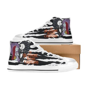 K&ouml;nnte beinhalten: Wei&szlig;e High-Top-Canvas-Schuhe mit einem schwarz-wei&szlig;en Zebra-Muster. Die Schuhe zeigen ein Grafikmotiv von Jack Skellington und Sally aus dem Film "Nightmare Before Christmas".