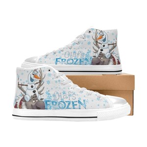 May include: White high-top canvas shoes with a snowflake pattern and a graphic of Olaf from Frozen riding Sven the reindeer. The shoes say "Olaf's Frozen" on the side.