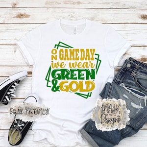 May include: White t-shirt with the text "On Gameday We Wear Green & Gold" in green and gold. The shirt is paired with blue jeans and black Converse sneakers. The words "Digital File ONLY!" are also visible.