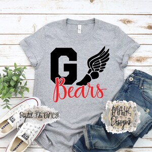 May include: A grey t-shirt with the text "G Bears" in black and red, featuring a winged foot graphic. The shirt is paired with blue jeans and white trainers. The words "Digital File ONLY!" are also visible.