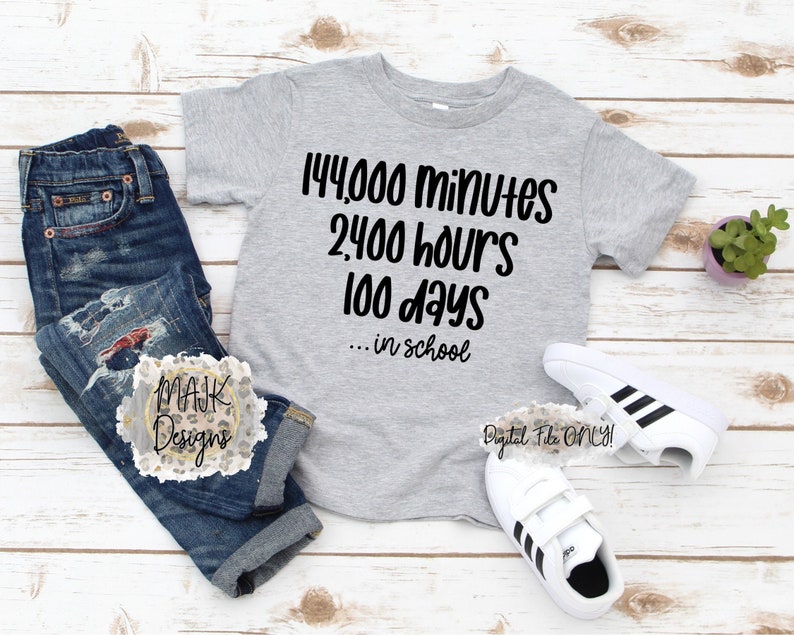 May include: A gray t-shirt with black text that reads "144,000 minutes 2,400 hours 100 days... in school". The shirt is on a wooden surface with a pair of white sneakers with black stripes and a small potted plant.