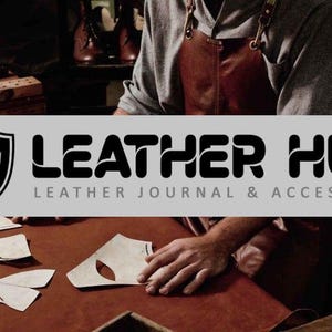 May include: A craftsman working with leather, surrounded by tools and materials. The image features the "MM Leather Hub" logo, with the text "Leather Journal & Accessories". The scene suggests a workshop environment.