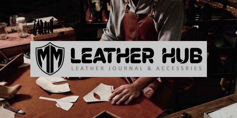 May include: A craftsman working with leather, surrounded by tools and materials. The image features the "MM Leather Hub" logo, with the text "Leather Journal & Accessories". The scene suggests a workshop environment.