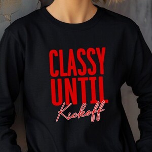 May include: Black long-sleeve shirt with the red text "Classy Until Kickoff". The shirt is made of a soft material and is suitable for casual wear. The shirt is a great gift for football fans.