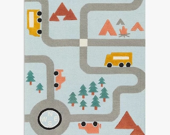 May include: A blue and gray play rug with a road map design. The rug features yellow and orange cars, green trees, and red mountains. The rug also includes a compass with the letters N, E, W, and S.