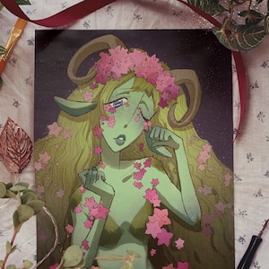 May include: A digital illustration of a green-skinned, female figure with horns and a flower crown. She has long, flowing green hair and is surrounded by pink flowers. The background is a dark blue with stars.