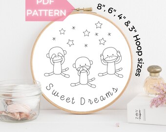 May include: A black and white embroidery pattern of three monkeys covering their eyes, nose, and ears with the text "Sweet Dreams" and stars around them. The pattern is designed for embroidery hoops in sizes 8, 6, 4, and 3 inches.