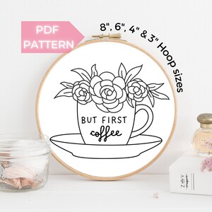 May include: Black and white embroidery pattern of a coffee cup with flowers and the text "BUT FIRST coffee". The pattern is designed for embroidery hoops in sizes 8, 6, 4, and 3 inches.