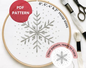 May include: A snowflake embroidery pattern in a wooden hoop. The design is stitched with silver thread and includes small white beads. The text "PDF PATTERN" is in a red circle. Hoop sizes are 8", 6", 4", and 3". The text "Clear pattern, ready to trace" is also included.