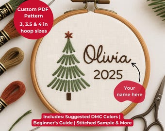 May include: An embroidery hoop with a stitched Christmas tree design, the name "Olivia" and the year "2025". The text "Custom PDF Pattern" and "3, 3.5 & 4 in hoop sizes" are also visible. Includes suggested DMC colors and a beginner's guide.
