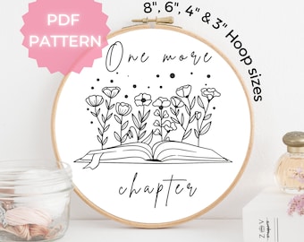 May include: A black and white embroidery pattern of an open book with flowers growing from it. The text "One more chapter" is written above the book. The pattern is available in 8", 6", 4", and 3" hoop sizes.