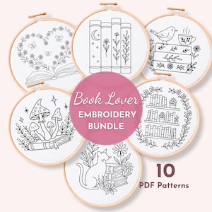 May include: Six embroidery hoops with black and white line art designs. The designs feature books, flowers, mushrooms, a cat, and a bird with a teacup. The text "Book Lover EMBROIDERY BUNDLE" is in a pink circle. The text "10 PDF Patterns" is also visible.