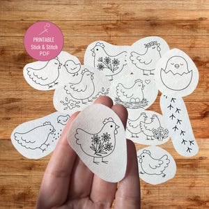 May include: A collection of printable stick and stitch PDF designs featuring various chicken illustrations. The designs include chickens with floral accents, chicks, and chicken footprints. The designs are on a wooden background.