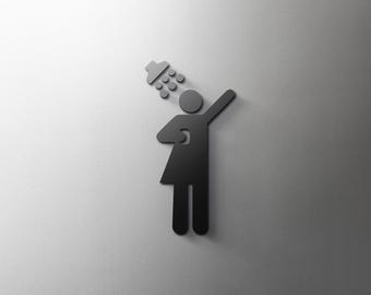 May include: Black silhouette of a person showering with water droplets coming from a shower head.