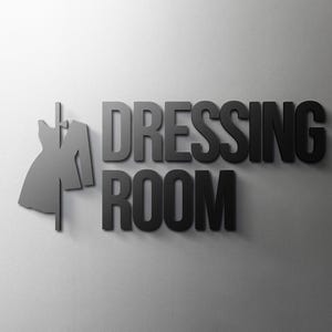 Könnte beinhalten: Ein schwarz-weißes Schild mit dem Text "DRESSING ROOM" und einer Silhouette eines Kleides an einem Kleiderbügel.