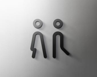 May include: Two black silhouette figures of people standing side by side on a white background.