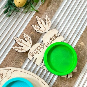 May include: Wooden Easter bunny cutout with the words "Happy Easter" and a green silicone mold in the shape of an egg.