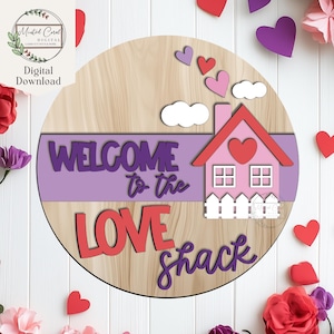 May include: A wooden round sign with the text "WELCOME to the LOVE shack". The sign features a pink house with a red heart, white clouds, and purple hearts. The background is a light wood grain.