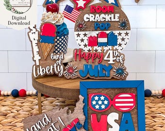 May include: A set of 4th of July themed wooden signs with red, white, and blue paint. The signs feature phrases like "Land of Liberty", "Happy 4th of July", "Boom Crackle Pop", and "Land That I Love".
