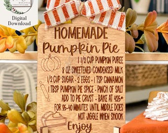 May include: A wooden sign with a red and white striped bow on top. The sign says "HOMEMADE Pumpkin Pie" and includes a recipe for pumpkin pie. The recipe includes ingredients like pumpkin puree, condensed milk, sugar, eggs, cinnamon, pumpkin pie spice, and salt. The sign also includes instructions to bake the pie at 425 degrees Fahrenheit for 35-40 minutes until the middle is set. The sign ends with the word "Enjoy".